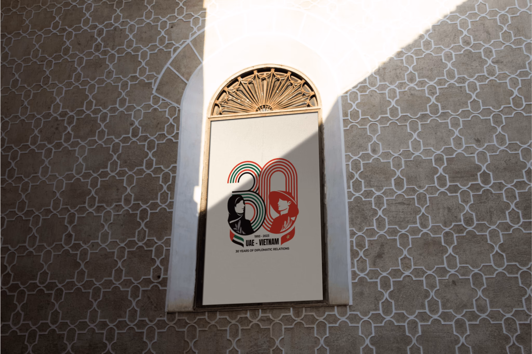 Celebratory mural featuring "30" with black and red graphics, set against a patterned wall backdrop.