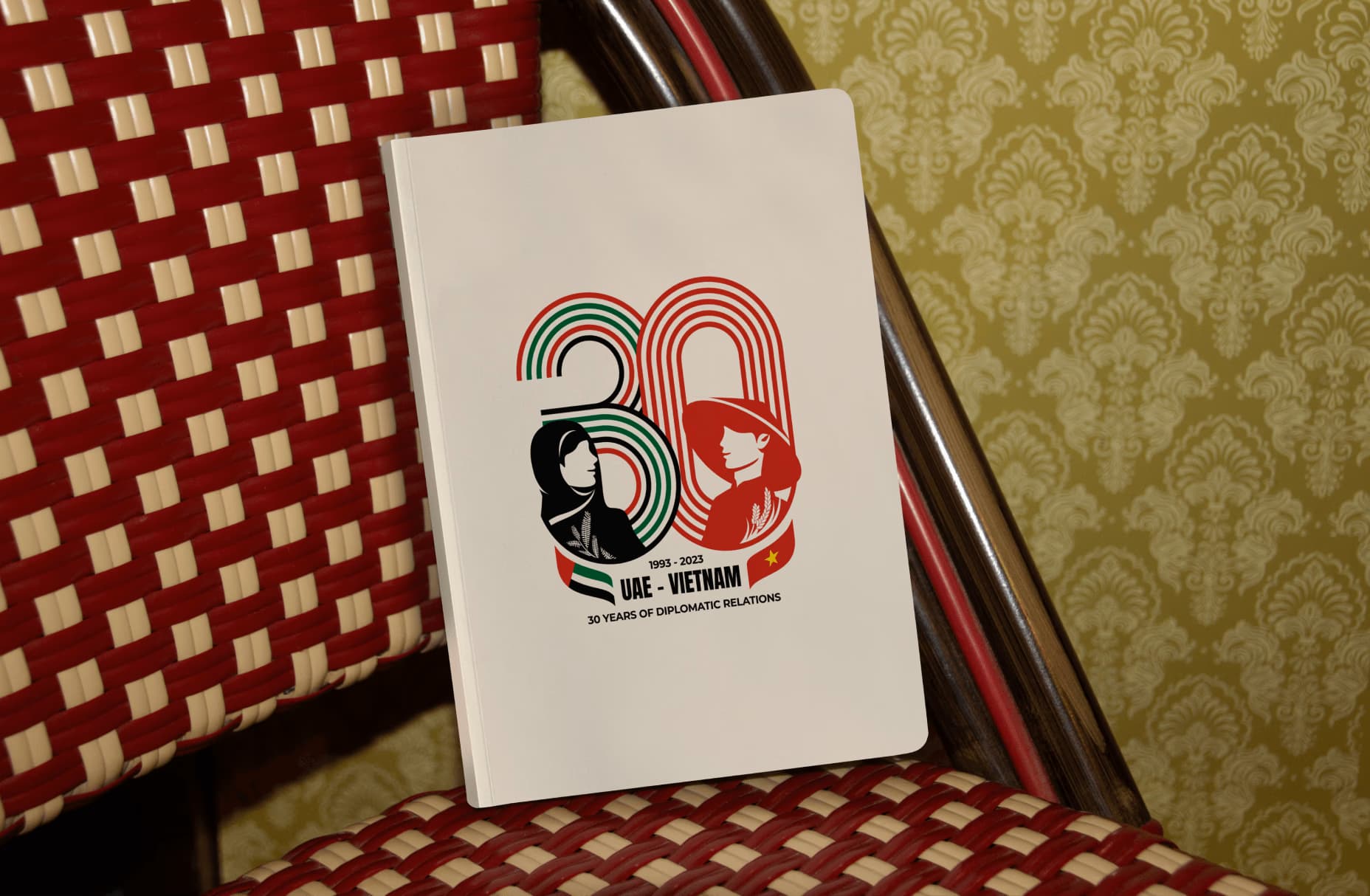 UAE-Vietnam 30 years of diplomatic relations commemorative booklet on a red woven chair