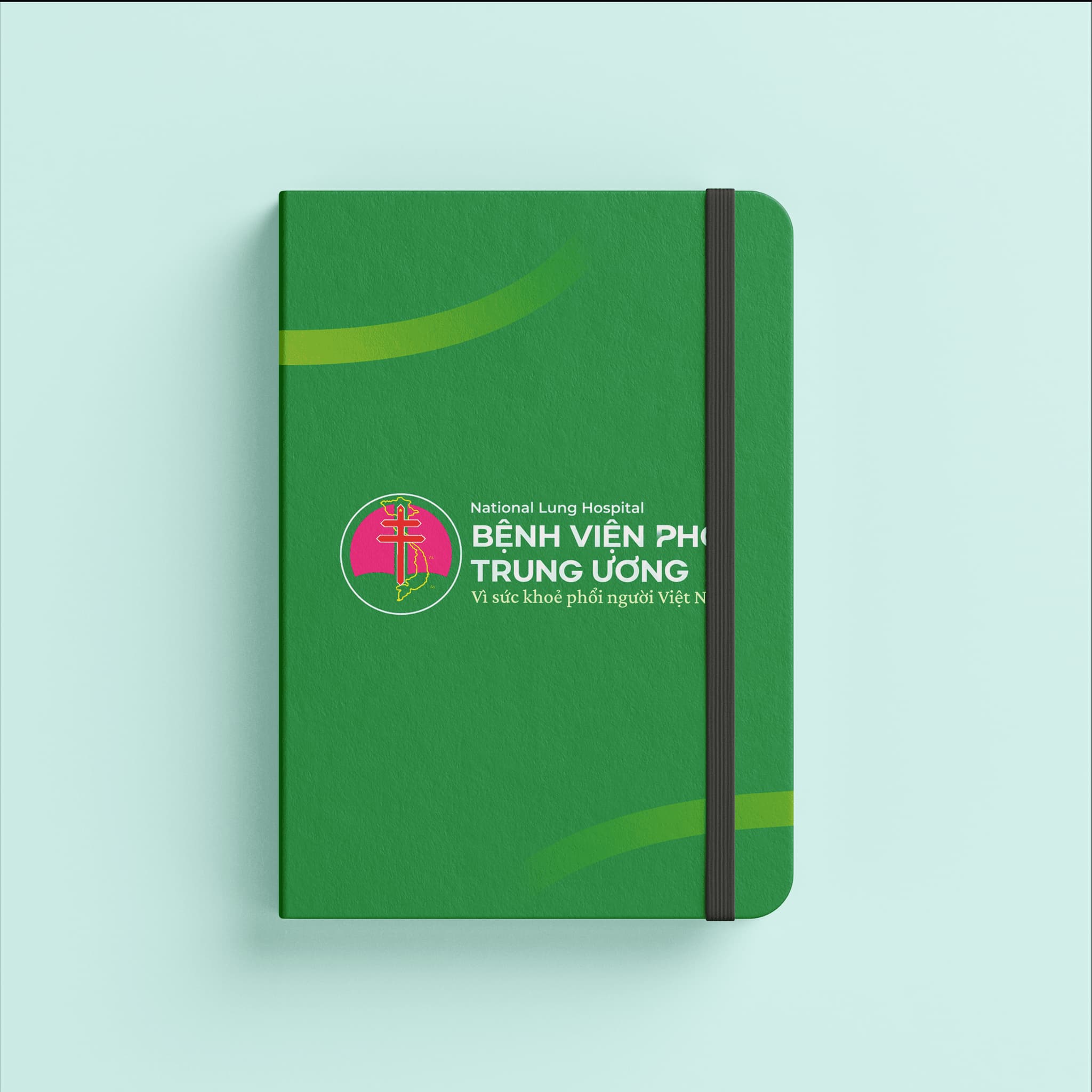 Green notebook featuring the logo of National Lung Hospital, Bệnh Viện Phổi Trung Ương, promoting health awareness.