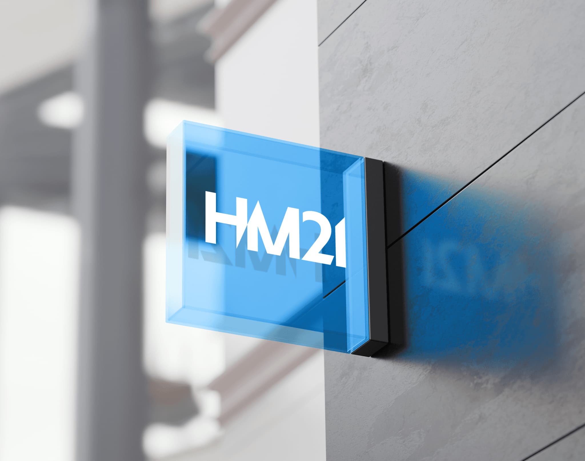 Modern blue logo design for HM21 displayed on a sleek wall, showcasing a contemporary branding style.