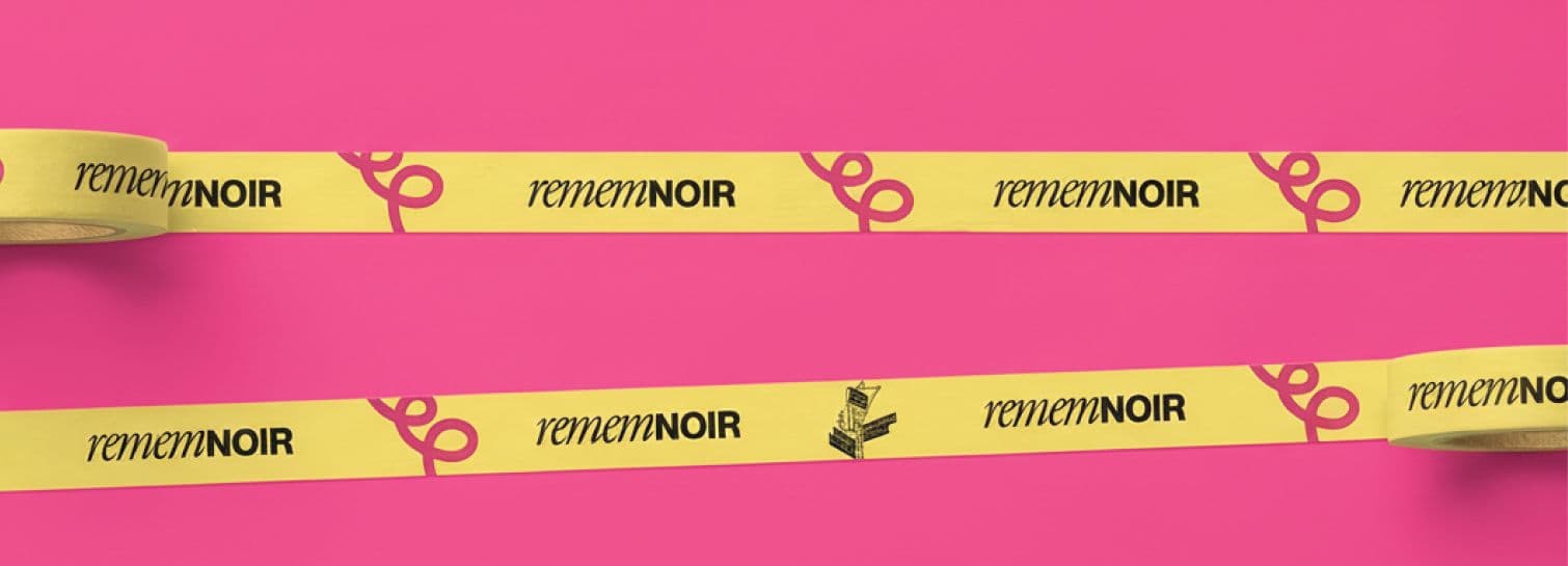 Colorful patterned ribbon tape with repeating “REMEMN/NOIR” and decorative icons in pink and gold