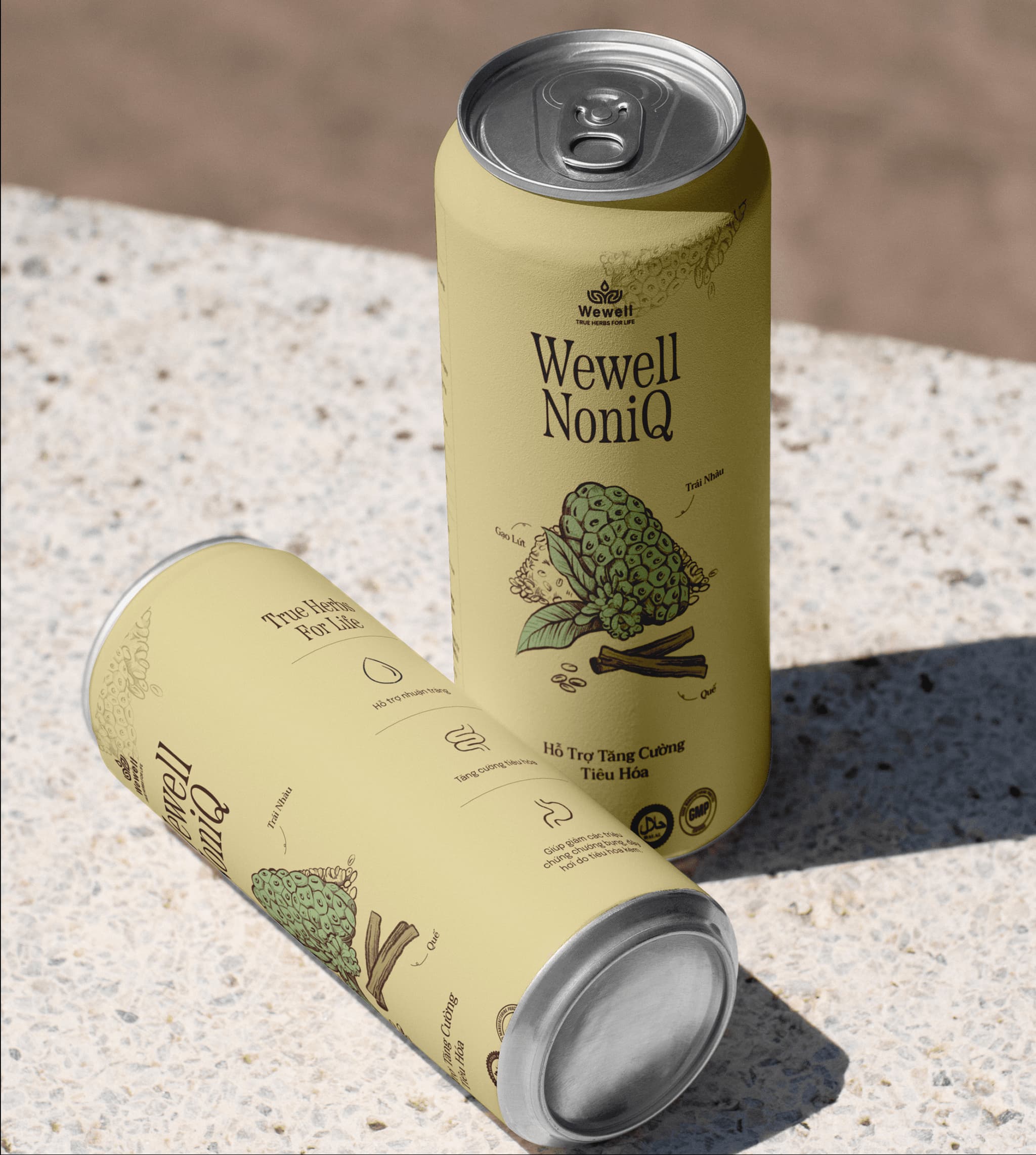 Cans of WeWell NoniQ beverage featuring a light yellow design and illustrations of noni fruit on a textured surface.