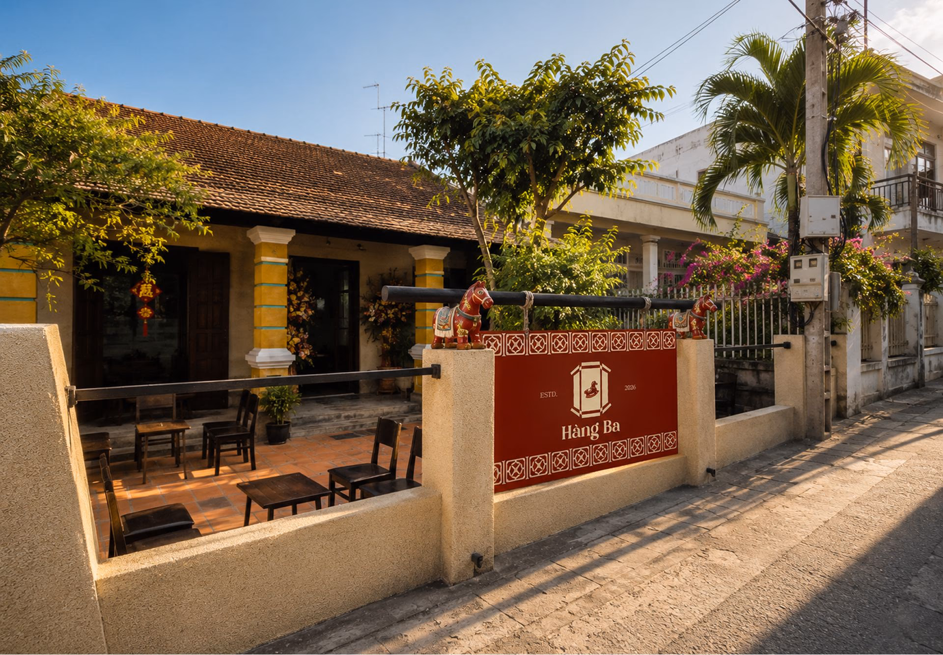 Tropical beachfront cove with palm trees and outdoor seating near Hàng Bà restaurant entrance