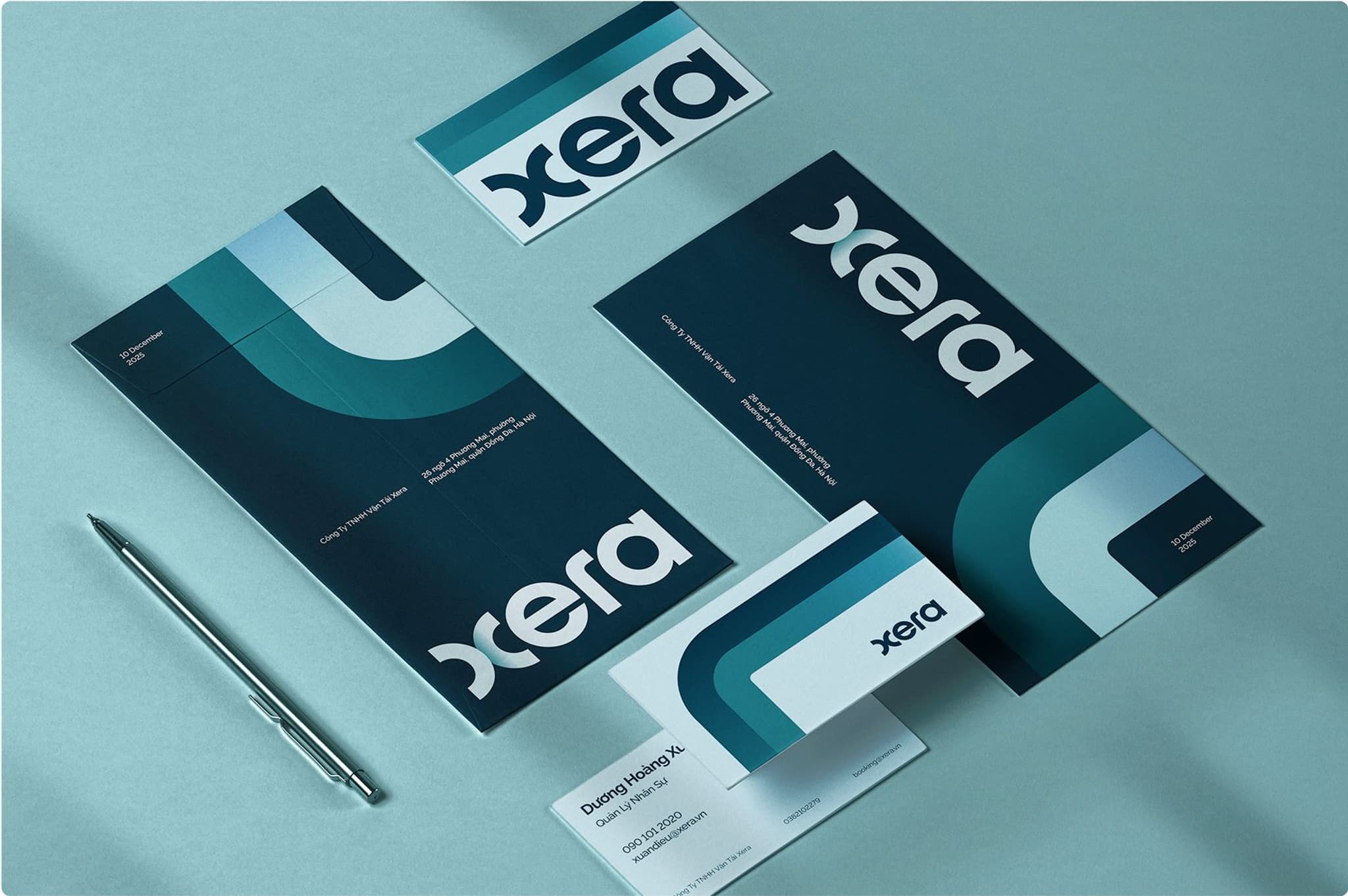 Branded stationery set featuring Xera logo, including business cards and letterhead, arranged on a teal background.
