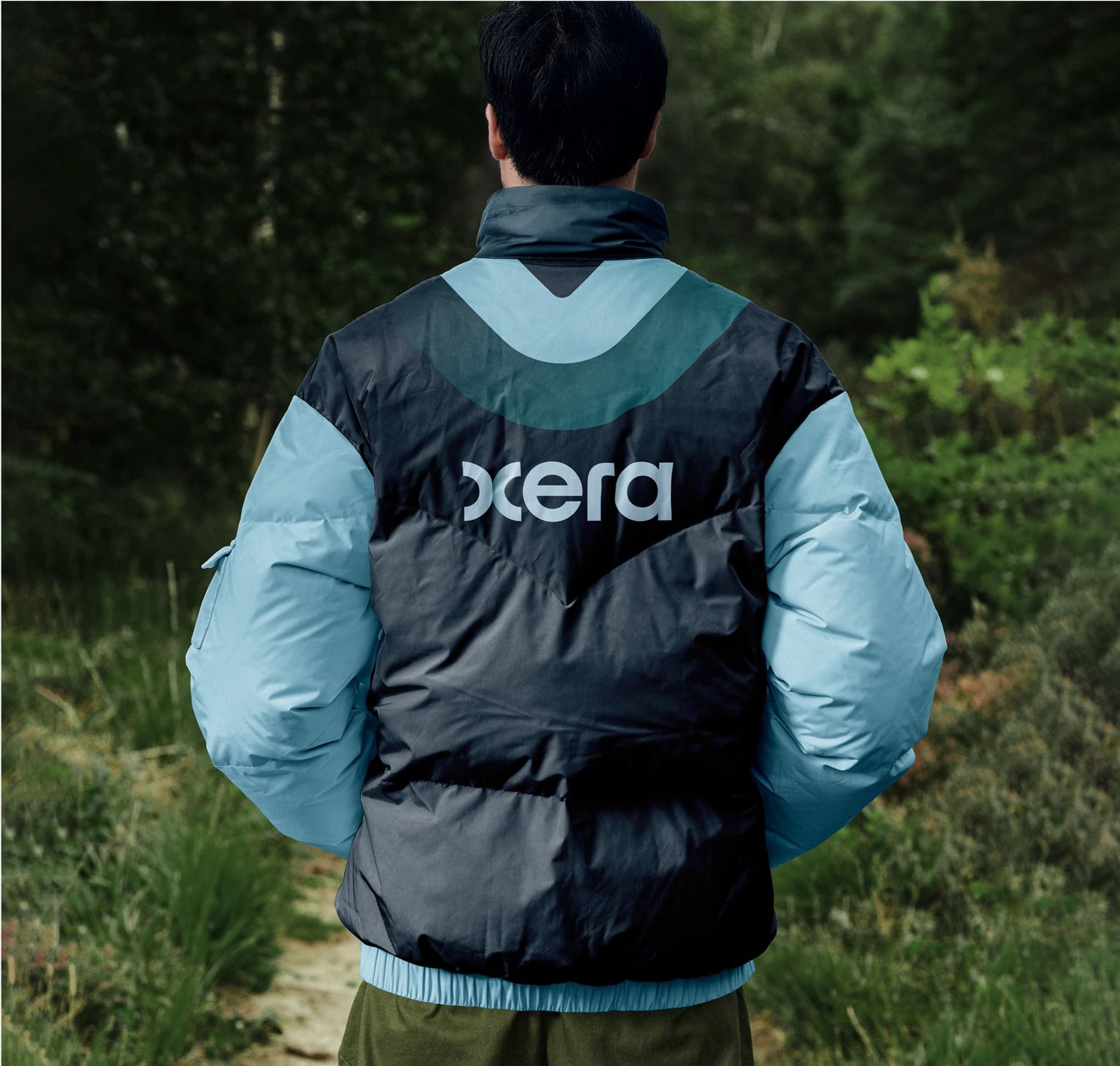 Stylish outdoor jacket in black and light blue, featuring the logo 'Oxera' on the back, ideal for cold weather adventures.